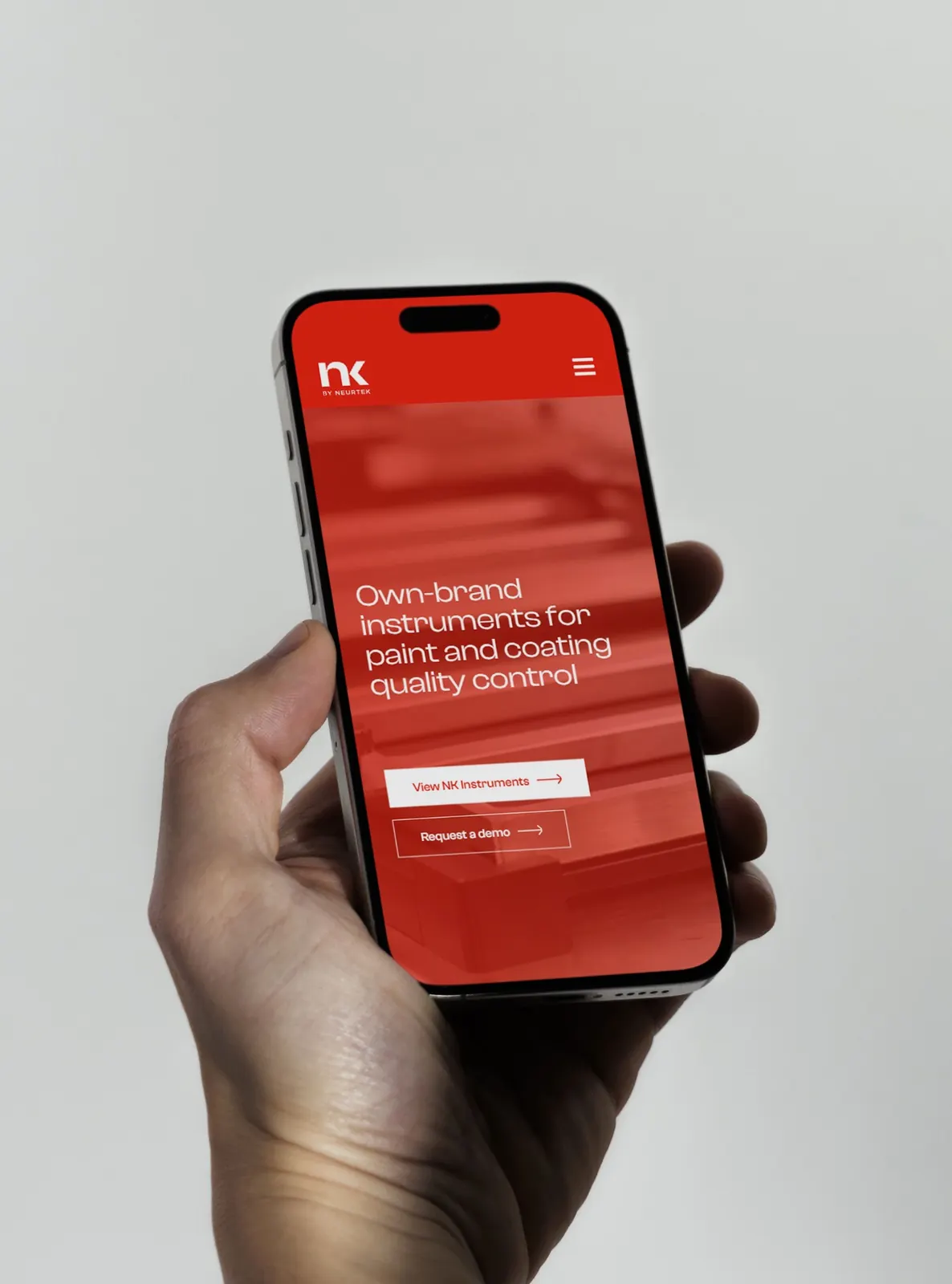 The NK by NEURTEK website on a phone held in the hand