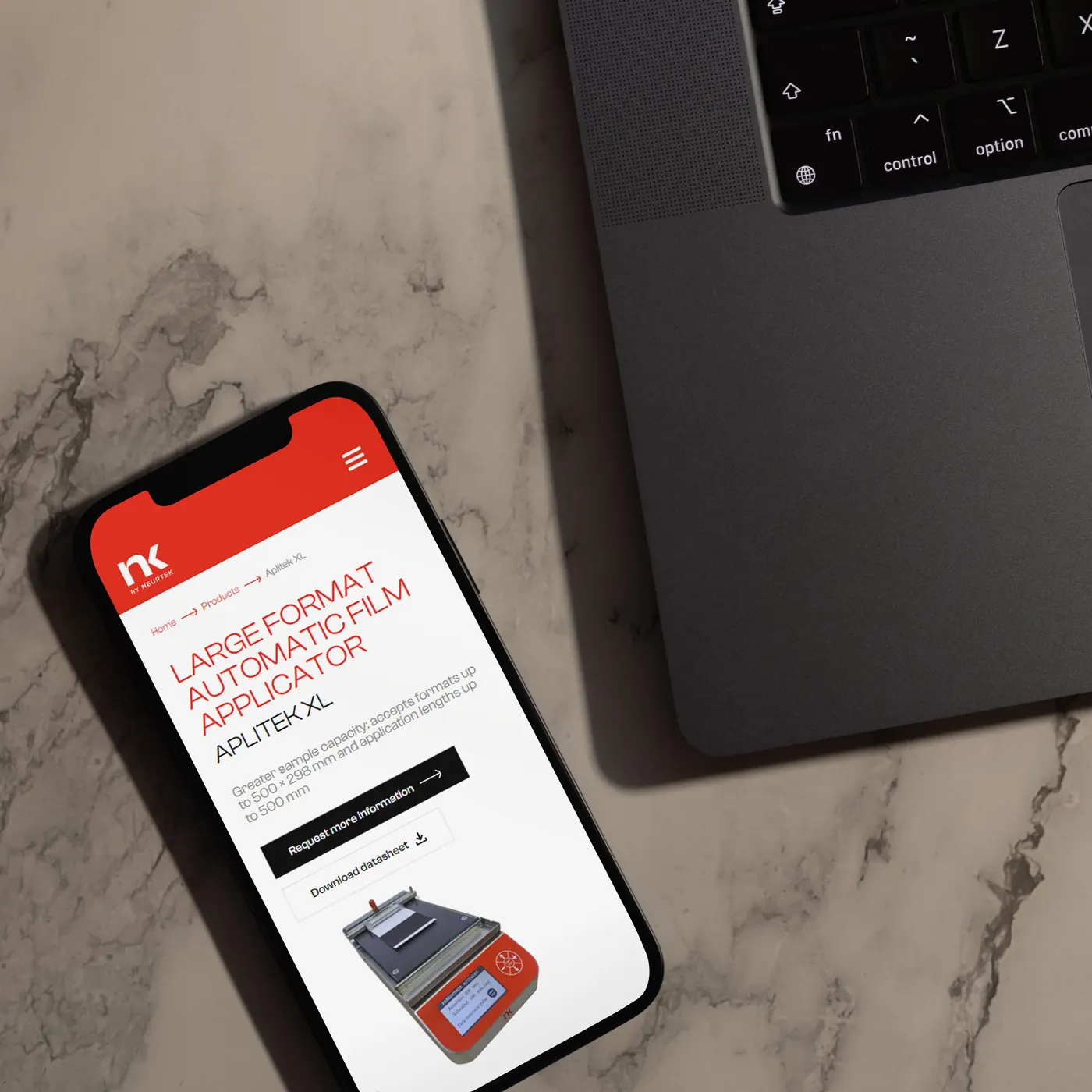 The Aplitek XL product page on a phone, next to a laptop